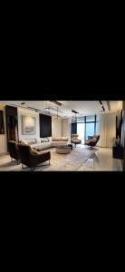 a large living room with a couch and chairs at منتجع شاطئ الدانة Hus Chalet in Dammam