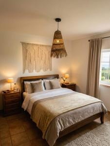 a bedroom with a large bed and a window at Casa do Arrozal Comporta in Comporta