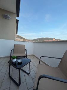 a balcony with a chair and a table and a view at MIALLEGRA Guest House in Bellona