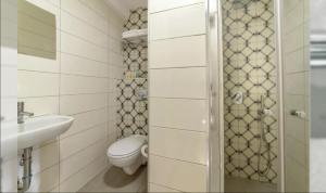 a small bathroom with a toilet and a sink at HYVE Jerusalem hosted by STAY in Jerusalem