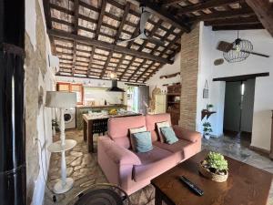 a living room with a couch and a table at La casa vieja de Marchenilla in Jimena de la Frontera