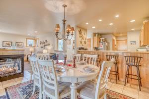 a dining room and kitchen with a table and a fireplace at A Mermaids Dream in Pacific City