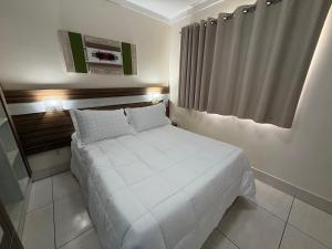 a bedroom with a white bed in a room at Lacqua diRoma in Caldas Novas +80 photos