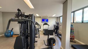a gym with treadmills and ellipticals in a room at Apartamento Premium com 2 quartos in Palmas