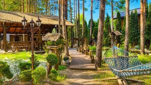 a wooden walkway leading to a cabin in the woods at Дом в лесу 1dom club in Protsev