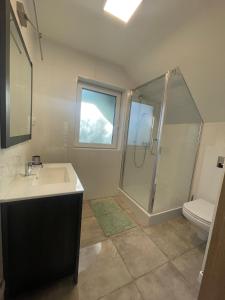 a bathroom with a shower and a sink and a toilet at Przylądek Werlas in Werlas +19 photos