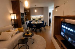a living room with a couch and a table at Apartament Pod Modrzewiem in Augustów