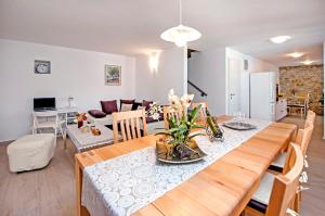 a dining room and living room with a dining table at Villa Masi in Kanfanar