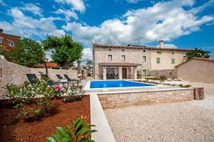 an exterior view of a house with a swimming pool at Villa Masi in Kanfanar