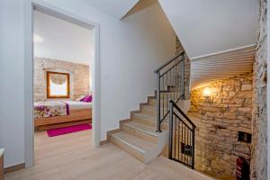 a staircase in a home with a stone wall at Villa Masi in Kanfanar +13 photos