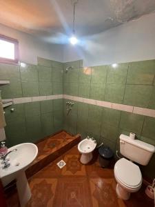 a bathroom with a toilet and a bidet and a sink at HOSTAL LUCERO in Humahuaca +19 photos