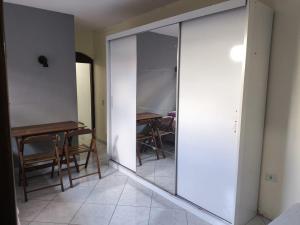 a mirror in a room with a table and chairs at Quarto Bem Localizado em Lugar Tranquilo in Barueri