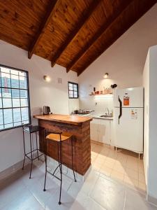 a kitchen with a counter and a refrigerator at Solymar Alojamiento in Puerto Madryn