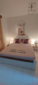 a bedroom with a bed with two towels on it at Andre House in Mesimvría