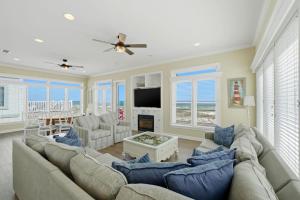 a living room with a large couch and a television at USA II in Gulf Shores