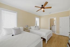 a bedroom with two beds and a ceiling fan at USA II in Gulf Shores +56 photos