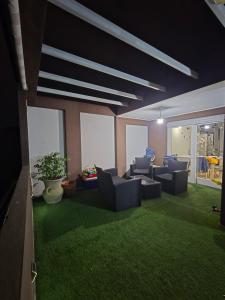 a living room with couches and green grass at Attico Casa ReGa - private parking and bbq in Quartu Sant'Elena