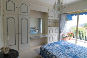 a bedroom with a bed and a large window at La Reale in Villefranche-sur-Mer +17 photos