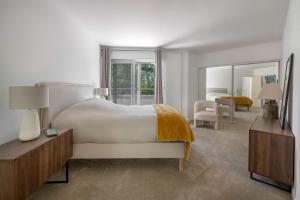 a bedroom with a large bed and a large mirror at Villa 96 Golf de la Baule avec piscine et spa in Saint-André-des-Eaux +16 photos