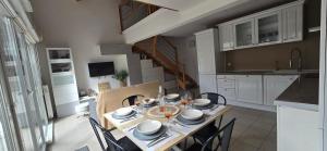 a kitchen and dining room with a table and chairs at L eden Maison en Camargue in Salin-de-Giraud