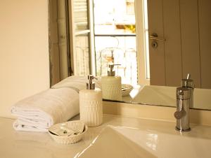 a bathroom with a sink and a mirror and towels at Inn Possible Lisbon Hostel in Lisbon +44 photos