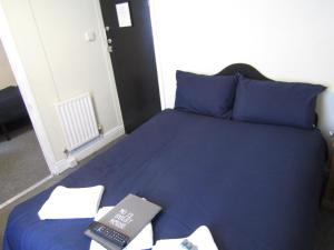 a bed with a book and a remote control on it at No Twelve in Blackpool