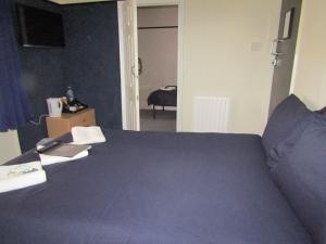 a bedroom with a bed with a blue bedspread at No Twelve in Blackpool