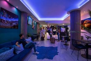 a man sitting on a couch in a living room at Urban Spaces Ibiza in Ibiza Town