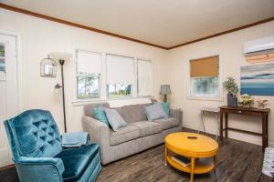 a living room with a couch and a table at Lake Huron Cottage 6 - 3 Bed 1 Bath in Lincoln Junction
