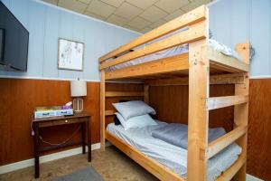 a bedroom with two bunk beds and a television at Lake Huron Cottage 6 - 3 Bed 1 Bath in Lincoln Junction +16 photos