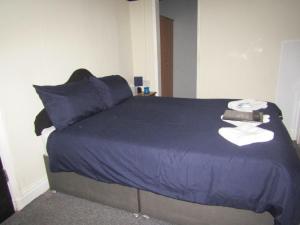 a bedroom with a blue bed with blue sheets at No Twelve in Blackpool