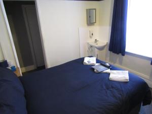 a bedroom with a blue bed and a sink at No Twelve in Blackpool +47 photos