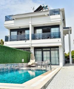 a house with a swimming pool in front of a house at Villa L Olivia 2 in Belek