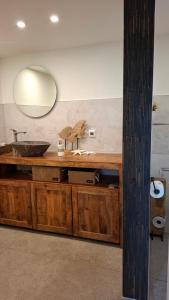 a bathroom with a sink and a mirror at Bungalow am Wald in Coswig +20 photos