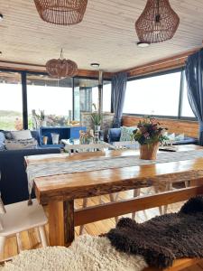 a living room with a large wooden table at PEZ HOUSE in Pichilemu