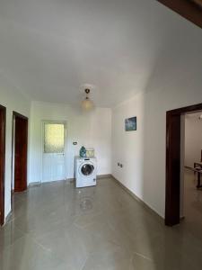 a living room with a washing machine in the corner at Guest House Ajasllari in Çorovodë
