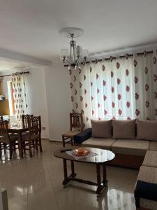 a living room with a couch and a table at Guest House Ajasllari in Çorovodë
