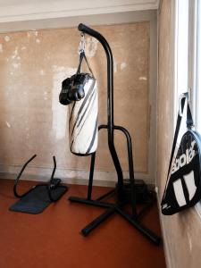 a room with a desk with a punching bag in it at Chambre dans villa privée, charme et confort proche Vélodrome & plages - Parking privé in Marseille