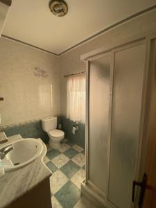 a bathroom with a toilet and a sink and a shower at Casa Magdalena in Archidona +7 photos