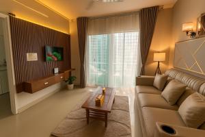 a living room with a couch and a table at NK Luxe Apartments - Full Furnished 2BHKs, Free Wifi, Smart TV, Central Location in Hyderabad