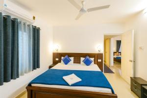 a bedroom with a large bed with blue sheets at NK Luxe Apartments - Full Furnished 2BHKs, Free Wifi, Smart TV, Central Location in Hyderabad