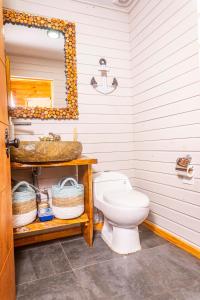 a bathroom with a sink and a toilet at PEZ HOUSE in Pichilemu +30 photos