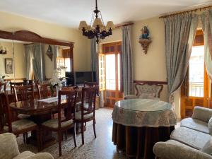 a living room with a table and a dining room at Casa Magdalena in Archidona