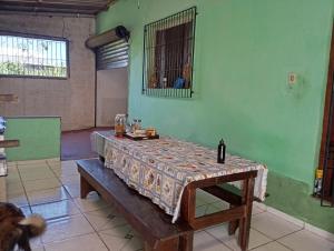 a table in a room with a table cloth on it at Férias pé na areia, sol e mar in Serra