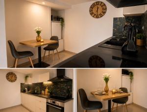 a kitchen with a table and a clock on the wall at Appartement T2 à la Campagne 10 min de Rennes in Corps-Nuds