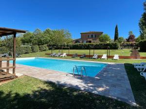a swimming pool in the backyard of a house at Villa Le Belle Giornate in Foiano della Chiana