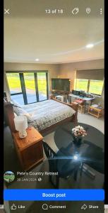 a bedroom with a bed and a desk and a table at Peter Country Retreat in Midhirst
