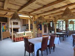a dining room with tables and chairs in a building at Hôte sahara & spa TADIGHOUST in El Hara