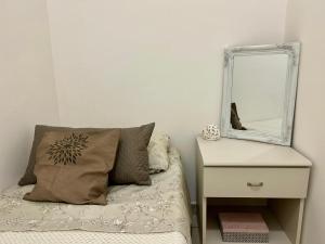 a bedroom with a bed with a mirror and a nightstand at diamond room in Palmi