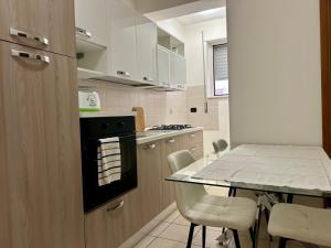 a kitchen with a table and a stove and chairs at diamond room in Palmi